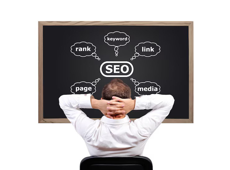 A man is sitting on the chair looking at the black board which writes SEO points 